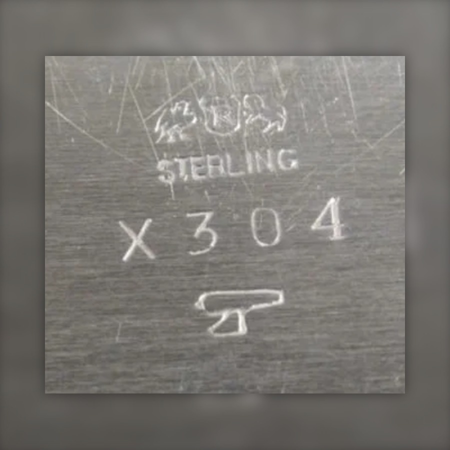 Reed & Barton Date Symbol Mark, 1928 to 1957 hallmark, A small pictorial symbol (for example an axe, arrow or horseshoe) struck beside the maker's marks, a different symbol for each year