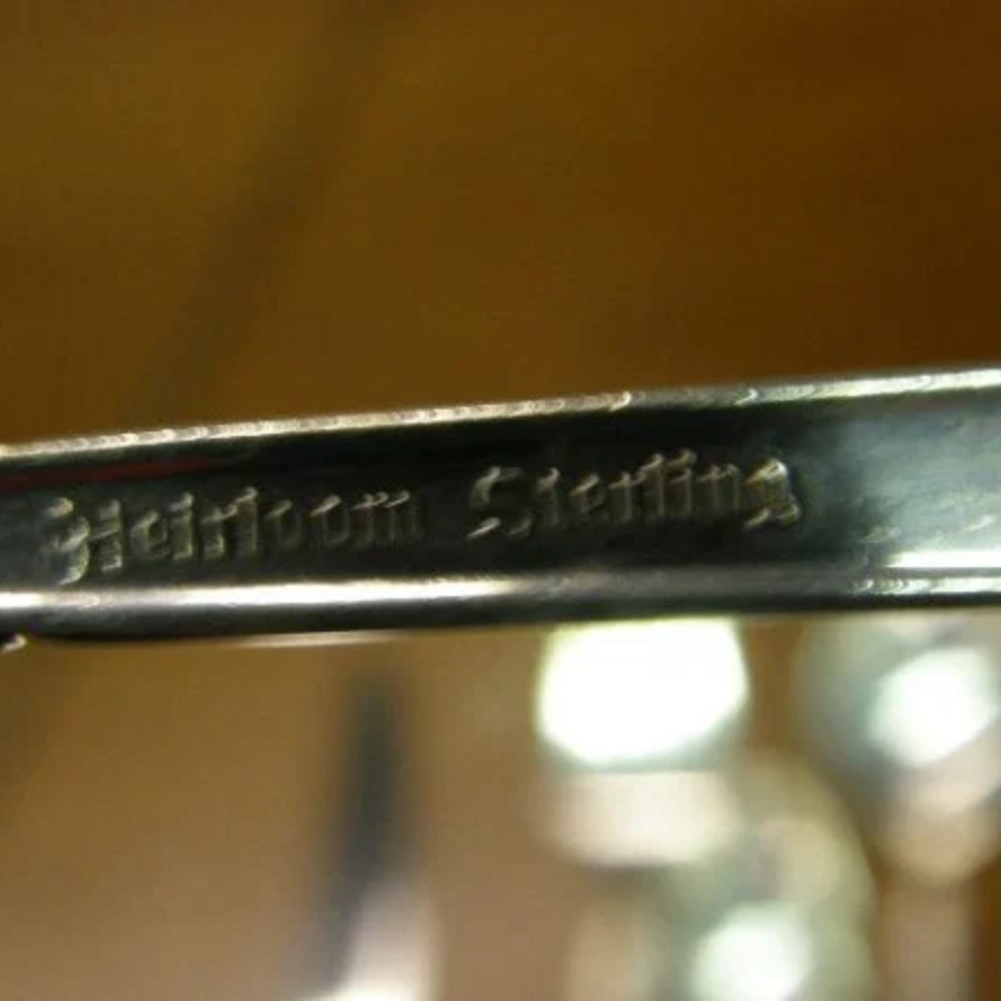 Oneida Heirloom Sterling Mark hallmark, The words HEIRLOOM STERLING, often with the pattern name, or ONEIDA STERLING. Knife blades may read HEIRLOOM STAINLESS