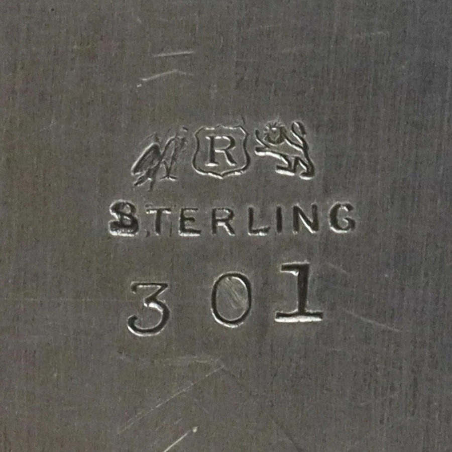 Reed & Barton Eagle, R and Lion Mark hallmark, Three small symbols in a row: an eagle, a capital R inside a shield, and a rearing lion, usually with the word STERLING